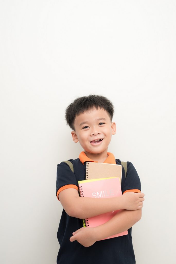 Child in Kindergarden with notepads