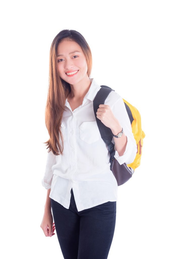 Beautiful asian university student smiling isolated over white background
